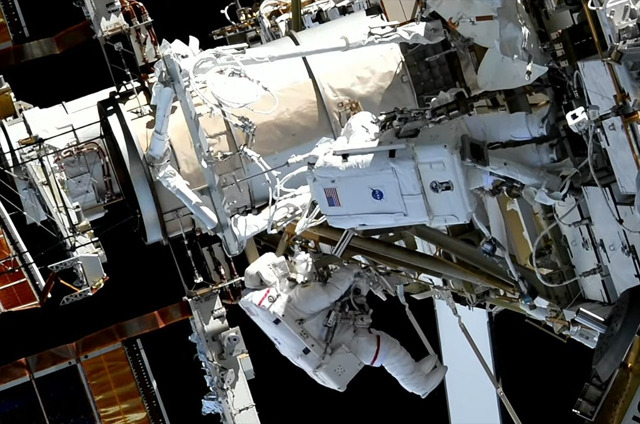 Spacewalking astronauts hit snags installing new solar array mount outside space station