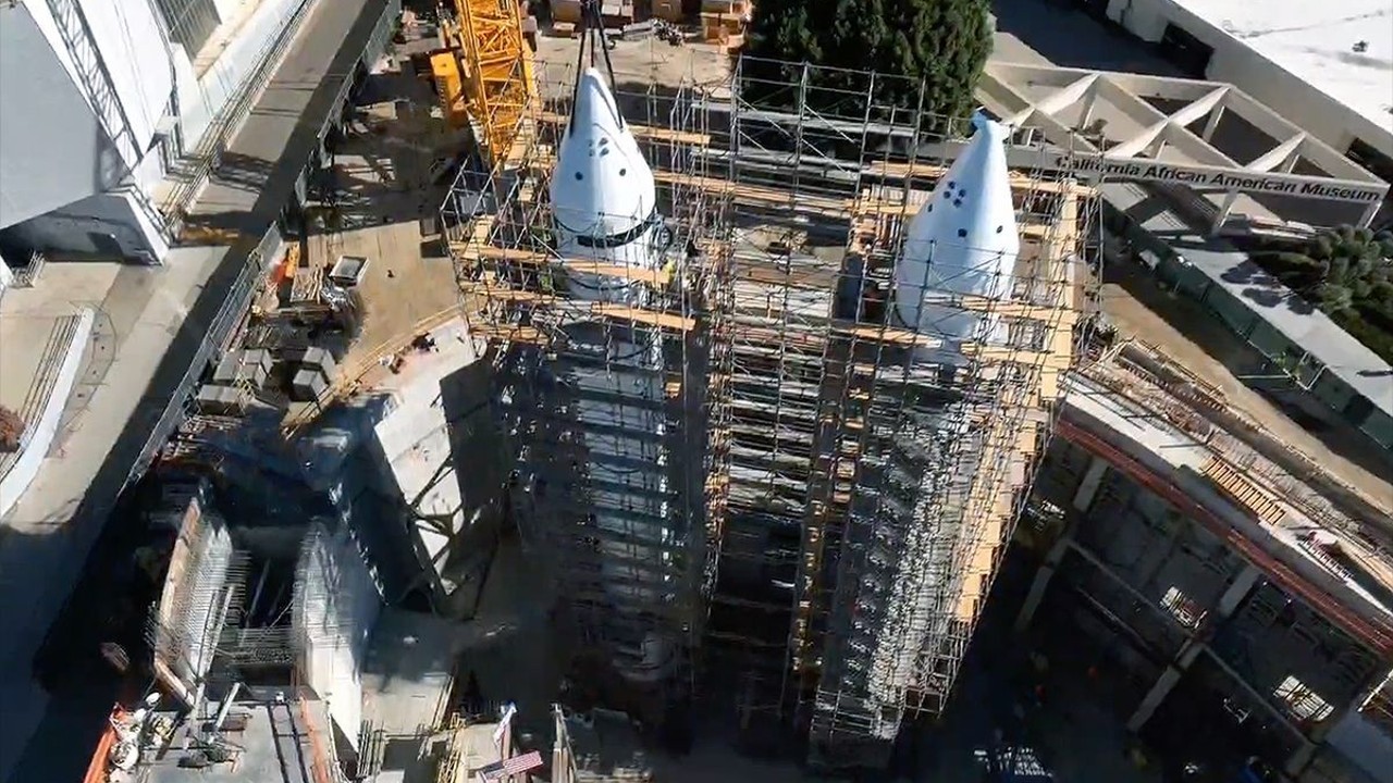 Solid rocket boosters for shuttle Endeavour exhibit capped with nose cones