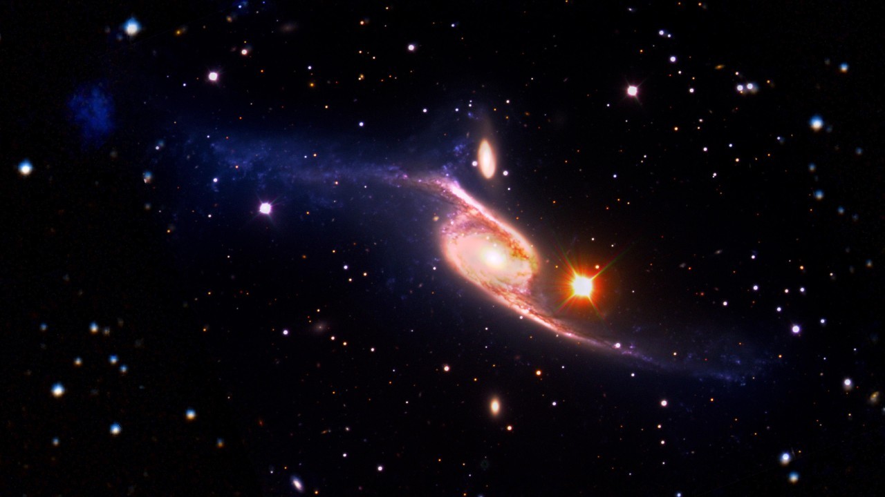 Largest known spiral galaxy in the universe shines in multi-telescope image