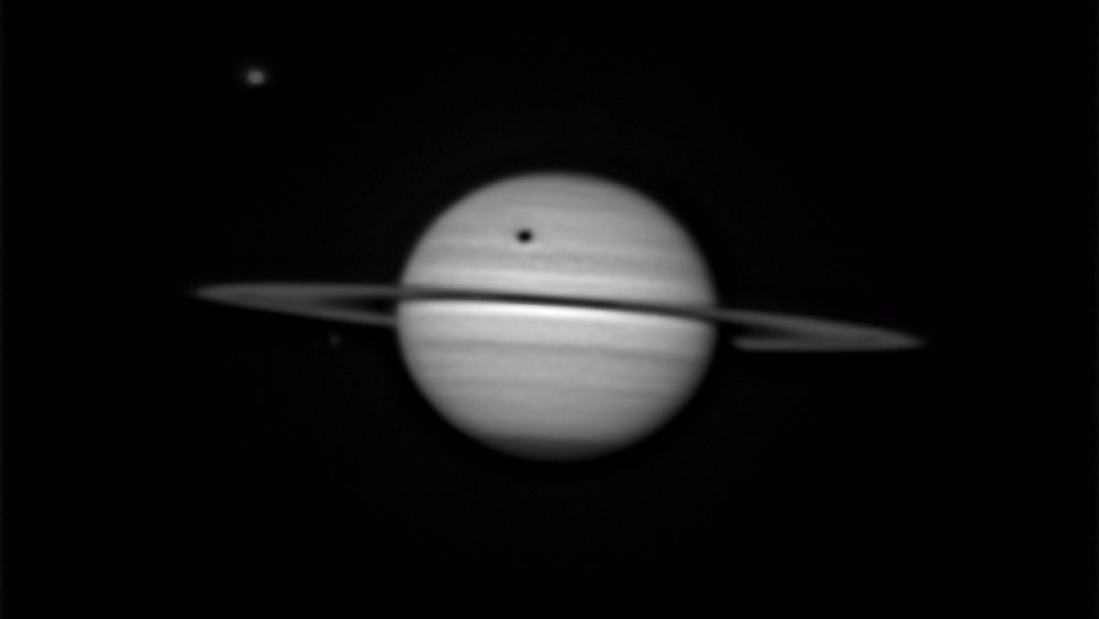 Saturn's largest moon Titan casts a colossal shadow in breathtaking amateur portrait (photo)